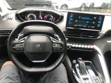 someone is sitting in the driver ' s seat of a car with their feet on the steering wheel
