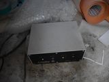 a box with a tape on it sitting on the floor next to a lamp