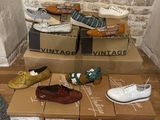 de nombreuses paires de chaussures qui traînent sur des cartons