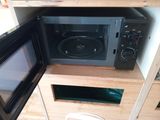 a microwave and a microwave oven in a small room