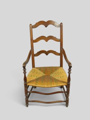 une vieille chaise en bois avec une assise jaune et un coussin jaune
