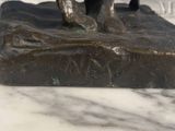 a statue of a man riding a horse on a rock
