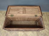 a wooden chest with a door open on a wooden floor