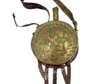 a gold colored purse with feathers hanging from it ' s handle