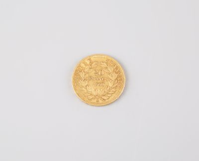 a close up of a gold coin on a white surface
