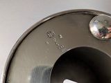 a close up of a toilet bowl with a button on it
