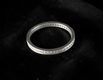 a ring that is laying on top of a black cloth