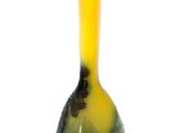 a yellow and green vase sitting on a white surface