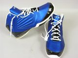 pair of blue and black shoes with white laces on a white surface