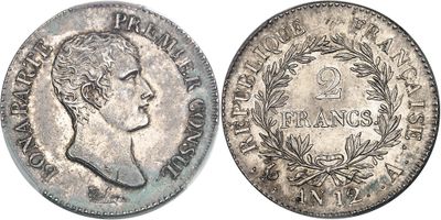 a close up of a coin with a woman ' s face on it