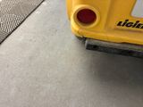 a close up of the back end of a yellow bus