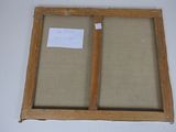 an old picture frame with a piece of paper attached to it