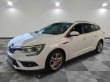 a white car parked in a room with a checkered floor