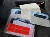 a car seat with a bunch of papers on it