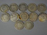 six different types of silver coins on a white surface