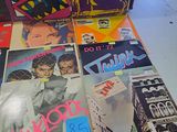 a lot of records sitting on a table in a room