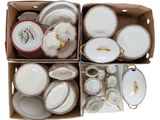 une boîte remplie d'assiettes et de bols blancs et dorés