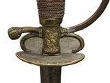 a close up of a sword with a handle on a plate