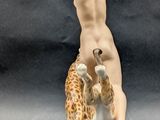 figurine of a woman with a giraffe and a giraffe