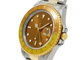 an image of a gold and silver watch with a yellow bezel