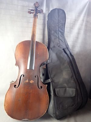 a violin sitting next to a guitar case on a couch