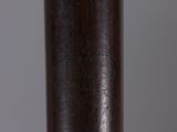 close up of a baseball bat on a table with a gray background