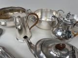 a table with a lot of silver items on it