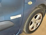 a close up of a blue car with a sticker on it