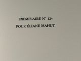 a close up of a white book with black writing on it