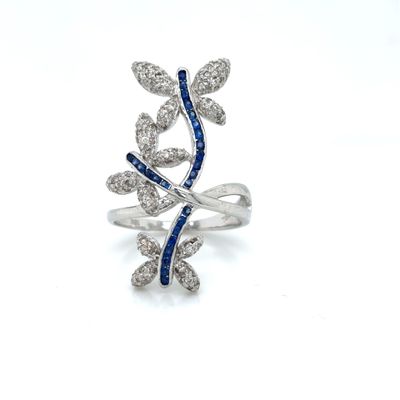 an image of a diamond and sapphire ring on a white background