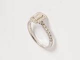 a close up of a diamond ring on a white surface