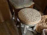 a small stool with a cushion on it in the corner of a room