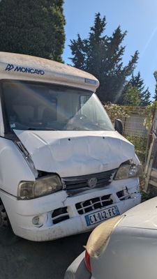 a white van that is parked next to a white car