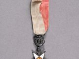 an image of a medal with a star on it on a gray surface