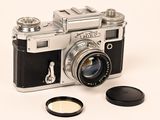 a camera with a lens attached to it and a lens cap