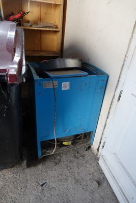 a blue trash can and a black trash can in the corner of a room