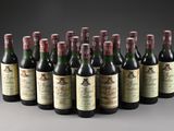 six bottles of wine lined up in a row on a gray surface