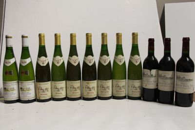 several bottles of wine are lined up in a row on a table