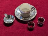 trois tasses et une soucoupe posées sur une nappe rouge