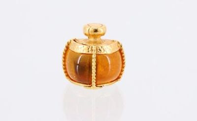gold and tiger eye glass perfume bottle on a white surface