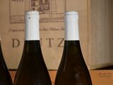 three bottles of wine sitting next to each other on a table