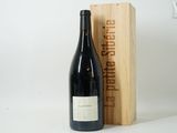 the bottle of red wine is next to a wooden box