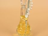 a small glass bottle with a flower inside of it
