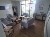 an image of a living room with couches and chairs