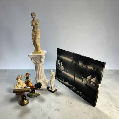 an image of a statue of a woman sitting on top of a table next to a picture of a man