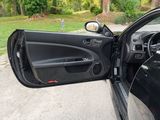 a black car with its door open on the street