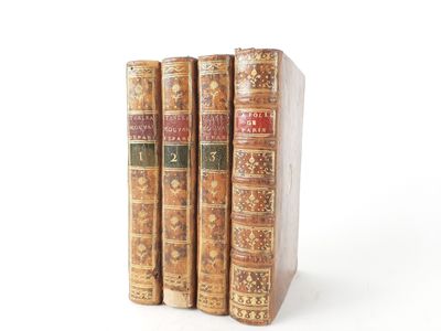 three books are stacked on top of each other on a white surface