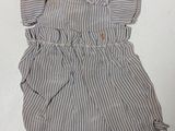 a picture of a baby girl ' s dress laying on the floor