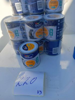 many cans of paint sitting on a table with a price tag