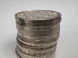 a stack of silver coins sitting on top of each other